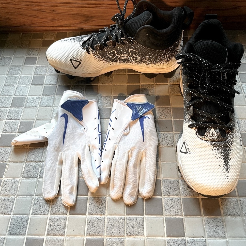 Boys size 5 under armour football cleats and Nike receiving gloves.